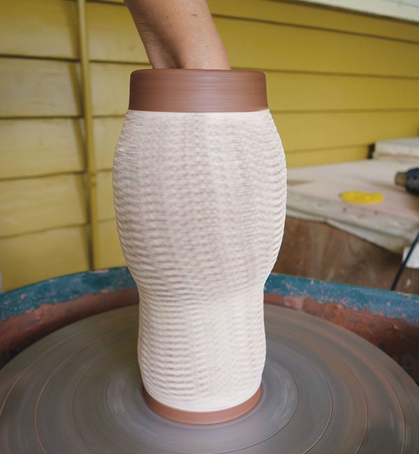 4 On the next stretch, continue to rib the cylinder from the inside, gradually moving downward and expanding the form.