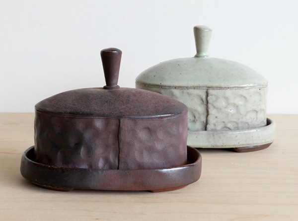 Ayla Murray's pair of butter dishes exhibiting wood-fired and oxidation surfaces, 2024.
