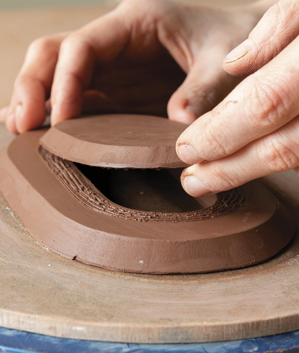 3 Refine the edges of the base, add texture to the bottom plate, and slip and score the areas where they will join.