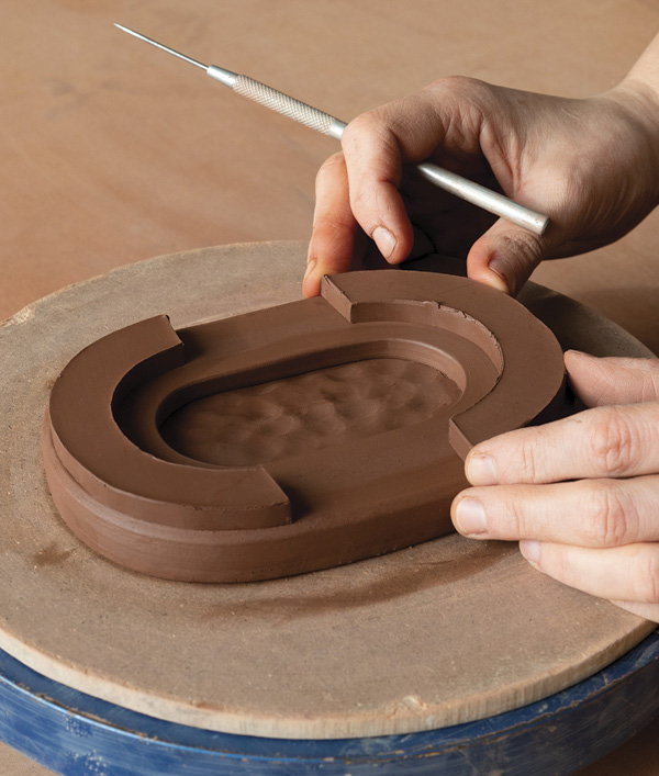 5 Mark the placement of the feet on the underside of the base and trace their outlines with a pin tool.