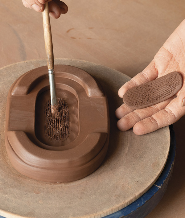 7 Cut out a thin slab, soften the edges, then slip, score, and attach it to the center of the cutout in the base.