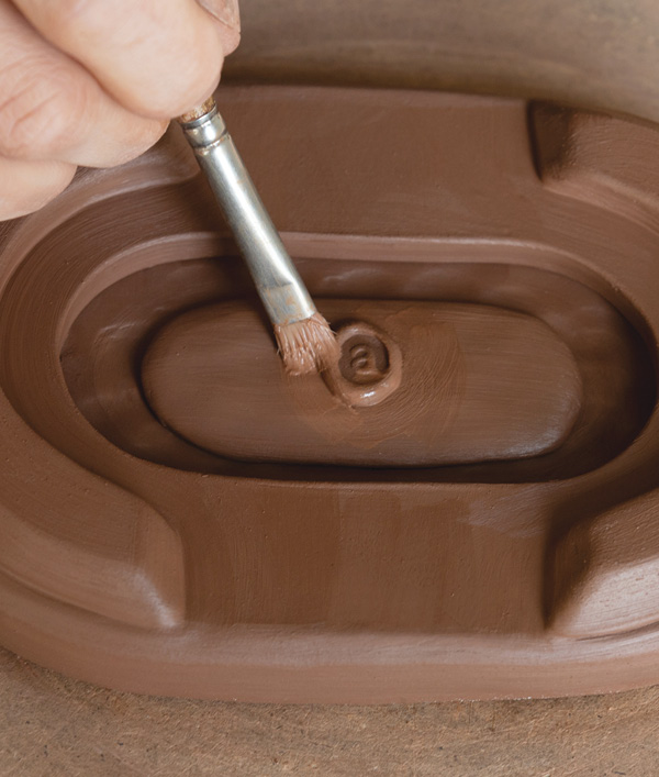 8 Complete the base by adding your signature or stamping a small ball of clay with your personal chop.